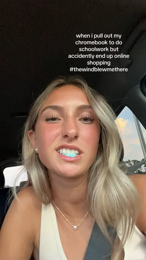 A young woman in a car, looking at the camera with a slightly surprised expression and a glow effect around her teeth, and text overlay.