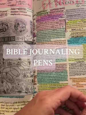 The cover image shows an open Bible with extensive notes and colorful highlighting. The left page has illustrations and annotations, while the right side features marked-up text with various highlighter colors. The lower right corner shows a hand reaching into the frame. Overlaid in the center is text that reads 'Bible Journaling Pens'.