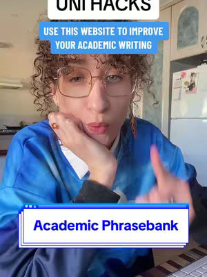 A selfie of a young woman with curly hair, wearing glasses, and a blue shirt with a design. She is looking directly at the camera with a thoughtful expression. Text overlays include "UNI HACKS" at the top and "USE THIS WEBSITE TO IMPROVE YOUR ACADEMIC WRITING" in a blue box above her head and "Academic Phrasebank" in a blue box at the bottom.