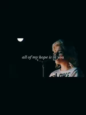 A dimly lit cover image features a person on a stage, singing into a microphone. Overhead, a semi-circular light illuminates the background.