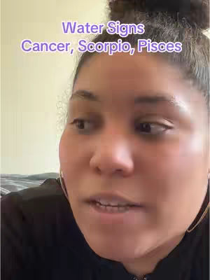 A medium shot features the creator with a somewhat obscured background. She has dark hair pulled up in a bun and is wearing hoop earrings. The image incorporates a lilac text overlay that identifies the content topic. The creator is positioned slightly off-center, gazing towards the left of the frame and appears to be speaking.