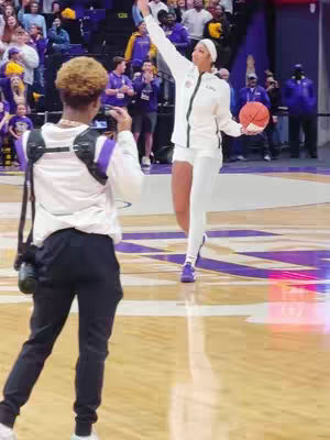 The cover image shows a person with a phone taking a photo of a basketball player. The basketball player wearing a white uniform and holding a basketball, is raising one arm and seems to be celebrating. The background includes audience members.