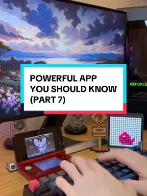 A person is shown working on a desk with a monitor showing a digital landscape background. In the foreground is a red and black retro game console and a black keyboard/mouse setup. The hook is over the video.