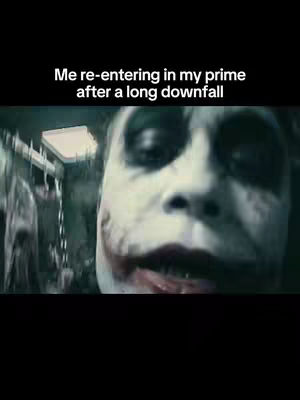 The cover image shows a close-up of the Joker's face from the movie 'The Dark Knight'. The Joker's face is centered, and he is looking directly at the camera, with the iconic makeup and a menacing expression. Behind him, a somewhat blurred environment suggests a chaotic or gritty setting. Above, there is white text on a black background.