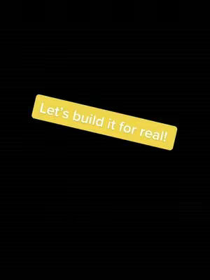 A simple cover image with a solid black background. A yellow rectangular shape is positioned slightly diagonally, towards the bottom-left. Inside this rectangle, the white text overlay reads, 'Let's build it for real!'