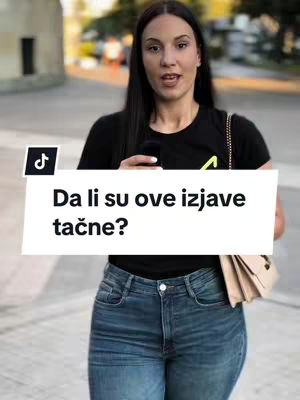 A woman in a black t-shirt and blue jeans stands outdoors, holding a phone. She is the central focus, with a white banner displaying text overlaying her image. The background suggests an urban setting with blurred elements.