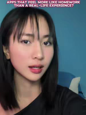 A woman with dark hair and a black top appears to be speaking to the camera in a selfie-style video. Above her head is text in a pink box. The background is a solid light blue. 