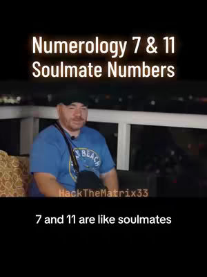 A man sits on a balcony with a blue shirt and a black hat, in front of a backdrop consisting of a series of white rails, and a dark background that appears to be the night sky; The title of the video overlaid in big white text at the top reads: "Numerology 7 & 11 Soulmate Numbers".