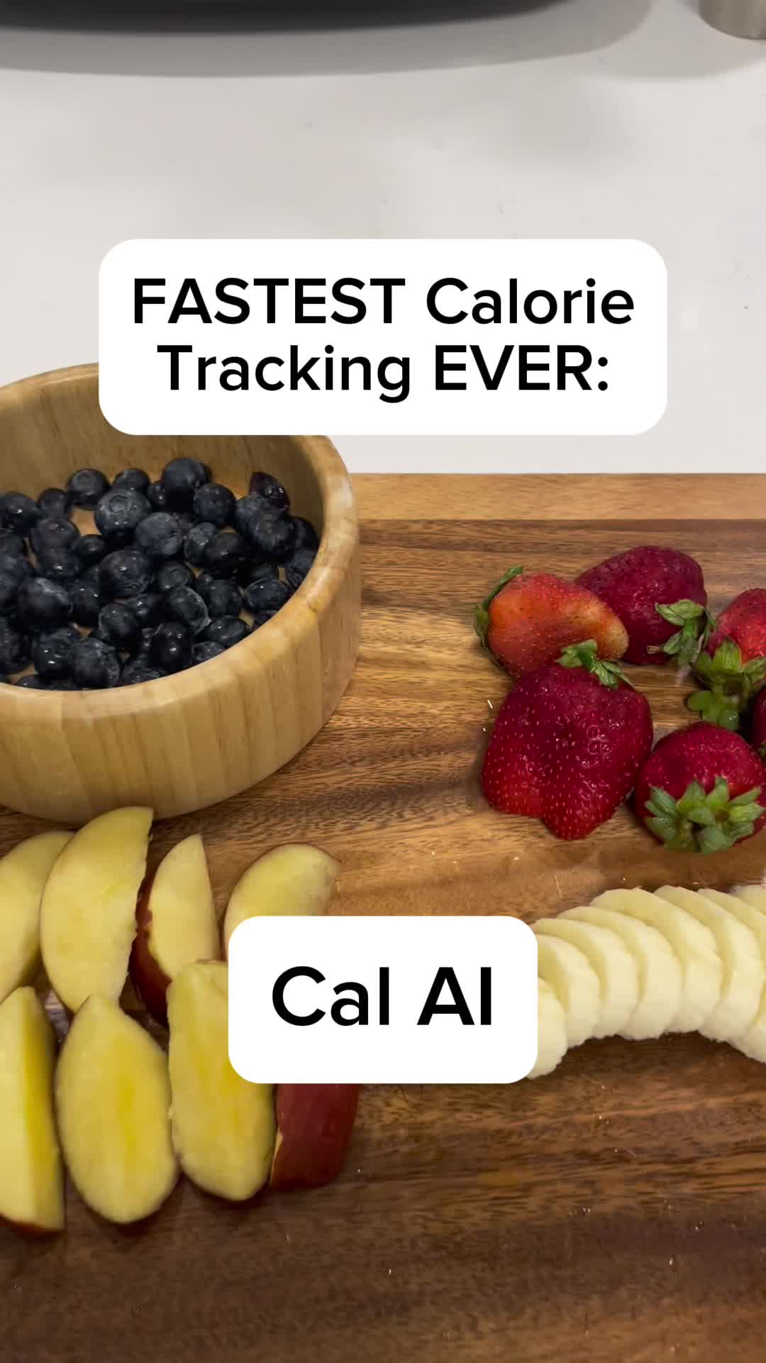 The cover image shows a wooden cutting board with various fruits: blueberries in a wooden bowl, red strawberries, sliced apples, and banana slices. Text overlays highlight the content.