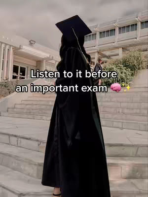A person in a graduation gown and cap stands with their back to the camera on some stairs. Text is overlaid with the words: Listen to it before an important exam. Small brain and star emojis are also added.