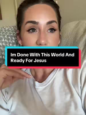 The cover image features a close-up of a woman’s face, centered in the frame. She has light skin, dark hair, and is looking towards the camera, with a slightly concerned expression. A black and teal text box is superimposed on the image, containing the words “Im Done With This World And Ready For Jesus”. Her posture suggests she is seated, with a white shirt that’s partially visible. The background appears to be a muted, neutral color, possibly representing a sofa or couch.