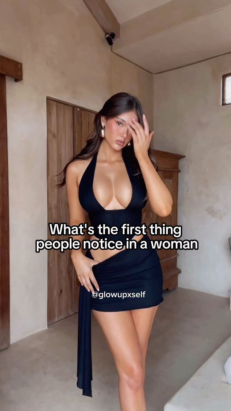 The image showcases a woman in a black outfit, with text overlayed. The woman is the central focus, posing in a way that draws attention to her. The background appears to be a neutral-toned interior. The color palette is minimal, with focus is on the woman's features and the black clothing she is wearing.