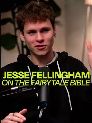 A young man with short brown hair wearing a black hoodie is the central figure. He faces the camera with a slight smile. Text in yellow and green overlaid on the lower part reads "JESSE FELLINGHAM ON THE FAIRYTALE BIBLE". The background is blurred, but appears to be an indoor setting. A microphone is positioned in front of the man and he has a small earring in his left ear.