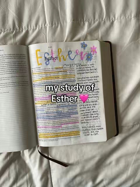 An open bible with handwritten notes and decorations on the pages, placed on a textured white surface. The text "my study of Esther" is superimposed on the image.
