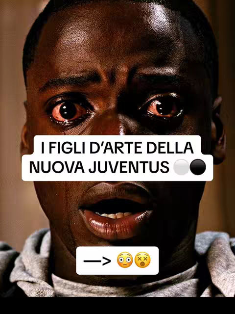 A close-up shot of a Black man's face, exhibiting a strong emotional expression. The man's eyes are wide and appear teary, and his mouth is slightly open. Overlayed on the image are white and black rectangular sections containing text in an Italian font with a series of emojis and arrows below them. The background is blurred.
