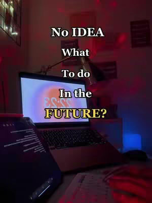 A dimly lit image shows a laptop open on a desk, with a tablet to the left. The laptop screen displays a colorful graphic with text that is difficult to read. Text overlays on the image ask 'No IDEA' and 'What To do In the FUTURE?' The scene is bathed in red and purple light.