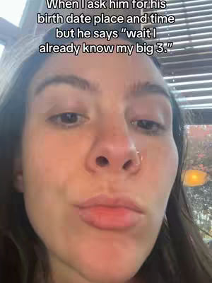 A selfie-style shot with the woman's face filling most of the frame. The background is out of focus, but hints at an indoor setting, possibly a restaurant. The woman has dark hair and is looking directly at the camera with a slight expression. Text overlay is at the top of the image.