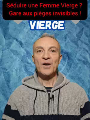 A man with a bald head is centered in the frame. He wears a gray hoodie and speaks, with a blue and grey backdrop.