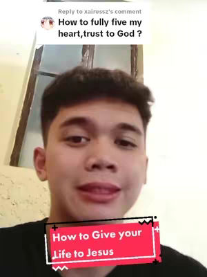 A young man with brown hair and a black shirt is centered in the frame, with a red banner superimposed on his lower chest. A speech bubble with text pops up on the top of the frame.