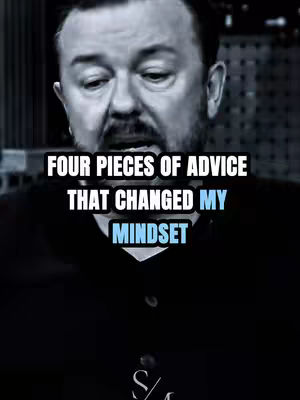 The cover image features a medium shot of Ricky Gervais with overlayed text. Gervais is looking down and to the left with a slight stern expression. He has dark hair and a beard. The text overlay is centered, with white letters and a light blue highlight for part of the word "Mindset". Background appears blurred but features an office setting.