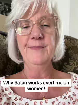 A close-up shot of an older woman with short, white hair and glasses. The image has a soft focus, with a text overlay at the bottom.