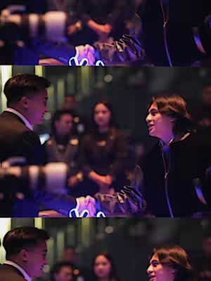 The image is a three-panel composite showing a medium shot of two men in a crowded setting. They appear to be in conversation; the focus is on their faces, with body language suggesting a close, possibly animated discussion. The background is softly blurred, suggesting a party or a social gathering, with many people in the background.