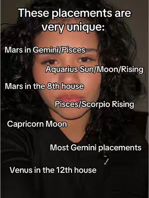 A selfie-style video cover featuring a young woman with dark curly hair, centered in the frame. Text overlays list various astrological placements in a white sans-serif font, stacked vertically against a dark background, with the woman's face serving as the primary visual element. Her expression is neutral, and the lighting creates a balanced exposure across her face.