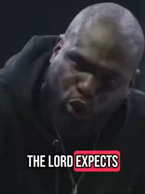 A close-up shot of a man's face with a text overlay. He appears to be speaking with his mouth open. The background is dark, and the focus is on the man's face, which is well-lit. A text overlay at the bottom reads "THE LORD EXPECTS" inside a red rectangle.