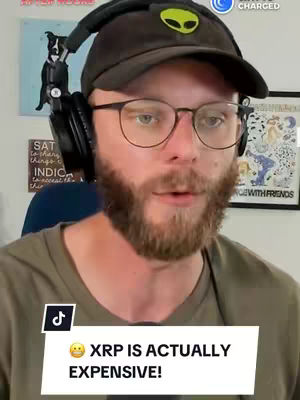 A man with glasses, a beard, and a cap with an alien logo is looking at the camera. A text overlay with a speech bubble says "XRP IS ACTUALLY EXPENSIVE!"