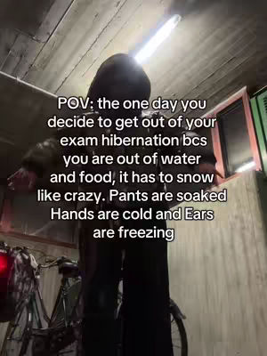 The image shows a person standing in what appears to be a dark, enclosed space, possibly a garage or storage area. The person, seen from the shoulders up, is wearing a dark, hooded jacket, and their face is largely obscured by shadows due to the low lighting. Above them, a bright, linear light fixture illuminates the scene. In the background, there is a bicycle and what seems to be a partial view of a window or wall, with some green visible. Text overlaid on the image provides context, discussing a situation relatable to the person's experience.