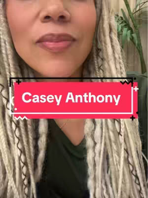 A close-up shot of a woman with light blonde, braided hair. A red rectangular overlay with the text "Casey Anthony" is centered on her chest. The background is slightly blurred, showing hints of an indoor setting.