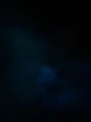 An abstract image dominated by a dark, deep blue color. The darkness suggests either a night scene or a space, with areas of slightly lighter blue giving the impression of clouds or fog. The image is very moody and evokes a feeling of depth or mystery.
