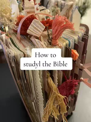 The cover image shows a close-up view of a heavily decorated Bible with multiple layers of pages and decorative elements. The Bible is open, revealing many pages. The overall composition gives a sense of depth and detail.