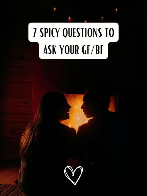 A silhouetted image of a couple facing each other in front of a fireplace. Text on a white box overlay says "7 Spicy Questions to Ask Your GF/BF." A white heart graphic is at the bottom.