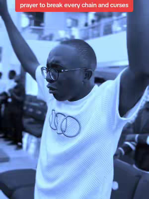 A man with glasses stands with arms raised, likely in a church or large building. A red banner above the image adds text. The overall tone is reverent or expressive.