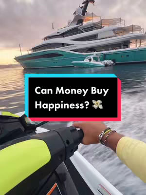 The image shows a person on a jet ski in the foreground, with a teal yacht in the background. The setting includes water and a cloudy sky. A text overlay in a black box reads "Can Money Buy Happiness?"