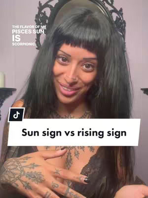 A woman with black hair and a dark top looks at the camera, with text overlayed. She has tattoos on her hands and arm . Behind her is a mirror.
