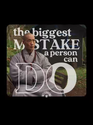 The image presents a middle-aged Asian man in a traditional grey robe, seated on a wooden bench with a backdrop of nature. Over this scene, white text layers read, 'the biggest MISTAKE a person can DO.' The text 'DO' is in a larger, bold font, superimposed across the man's figure. The composition integrates the man with the message, utilizing a muted color palette dominated by greens and greys, and a black background.
