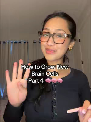 A woman with dark hair and glasses is smiling at the camera, holding up four fingers. Text overlayed reads 'How to Grow New Brain Cells Part 4'. There are three brain illustrations after that text. The background includes curtains.