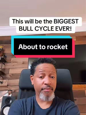 A man in a dark blue shirt sits in front of a wooden wall, with text boxes overlayed on top. The top text box reads, "This will be the BIGGEST BULL CYCLE EVER!" and the bottom box states, "About to rocket."