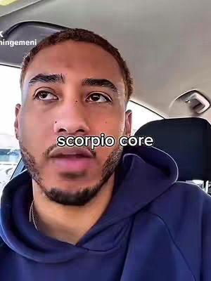 A man in a blue hoodie is sitting in a car, with the text overlayed on the image saying 'scorpio core'.