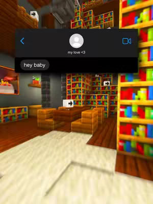 A screenshot of a chat interface in a Minecraft style setting. A black chat bubble on screen with the text "hey baby" is visible. Above are display pictures, name and call icons with the text "my love <3". The background consists of Minecraft-style bookcases.