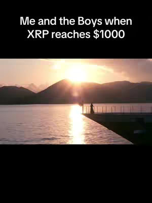 The image shows a beautiful landscape at sunset. The sun is setting over a body of water, with mountains visible in the distance. A person is standing on a pier, silhouetted against the light.