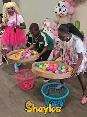 A group of people participating in a party game, with colorful balls and baskets.