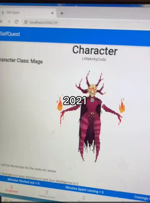 The cover image shows a computer screen displaying an app interface. The screen is white, showing the app elements and text overlayed on it. At the top of the screen is the name “SelfQuest” in a blue bar. In the middle of the screen there is a pixelated character with a horned skull-like face. Below the character, the word “2021” is written. The computer screen is framed by the black borders of a laptop, and some of the app interface's details are partially visible.