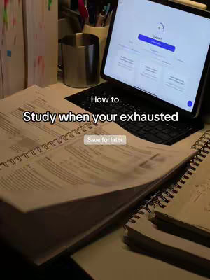 The cover image shows a workspace with an open textbook, notebooks, a mug, pens, and a tablet displaying study material. Text overlays indicate a tutorial or how-to video about studying while exhausted.