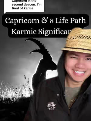 The image shows a person with light skin smiling at the camera. In the background, there is a black silhouette of a goat. On top of the background, there's a text overlay reading "Capricorn & 8 Life Path Karmic Significance". The person wears a hat, necklace, black jacket with a logo of a brand, and a black hoodie underneath. The background appears to be in black and white, with the sun rising or setting in the back.