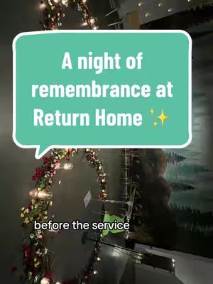 The image shows an interior scene, likely a hall or sanctuary. A large archway, adorned with red and white flowers, dominates the lower portion, leading the eye upwards toward the scene. Soft lights are interspersed throughout. A teal speech bubble with text is superimposed. The background has soft lighting and appears to be a detailed mural.