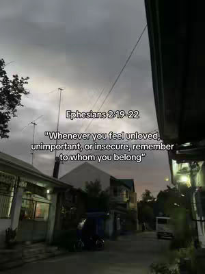 An overcast sky frames a narrow street scene, filled with muted tones of grey and beige. Buildings line both sides, with a slightly blurred background. Text overlayed in white.