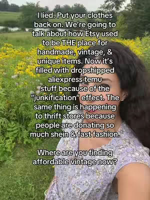 A selfie-style shot featuring a woman in the foreground with text overlayed. The background is blurred, showing a natural outdoor setting with greenery and yellow flowers. The woman is wearing a floral-patterned top and appears to be addressing the camera, potentially sharing opinions related to Etsy and vintage shopping.
